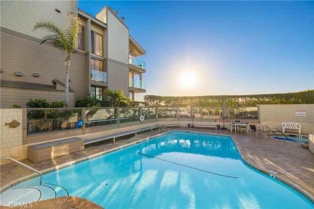 335 W I St, Encinitas, CA 92024 - pool at dusk with a community pool, a fenced backyard, and a patio