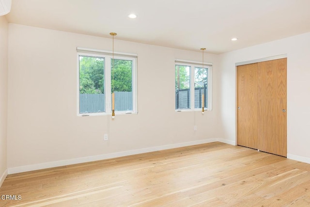 987 Bell St, Pasadena, CA 91104 - unfurnished bedroom with light wood-type flooring, multiple windows, recessed lighting, and a closet