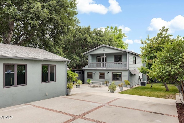 987 Bell St, Pasadena, CA 91104 - rear view of house with a balcony, a patio, a yard, roof with shingles, and stucco siding