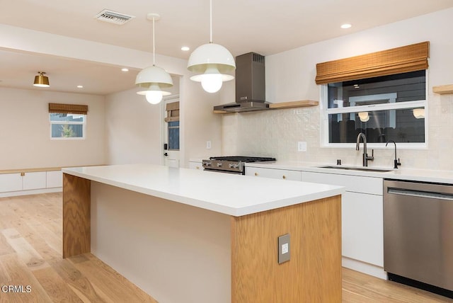 987 Bell St, Pasadena, CA 91104 - kitchen featuring appliances with stainless steel finishes, island range hood, light wood finished floors, white cabinetry, and a center island