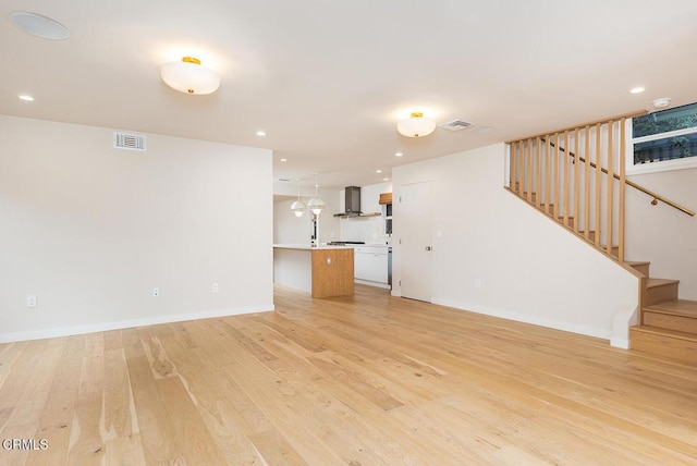 987 Bell St, Pasadena, CA 91104 - unfurnished living room with light wood-style flooring, stairs, and recessed lighting