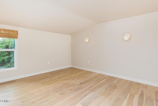 987 Bell St, Pasadena, CA 91104 - spare room featuring vaulted ceiling and light wood finished floors
