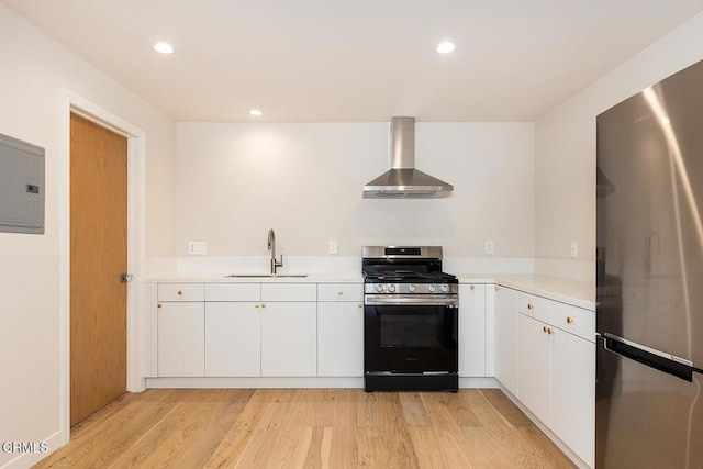 987 Bell St, Pasadena, CA 91104 - kitchen with stainless steel appliances, wall chimney range hood, light countertops, light wood-style flooring, and recessed lighting