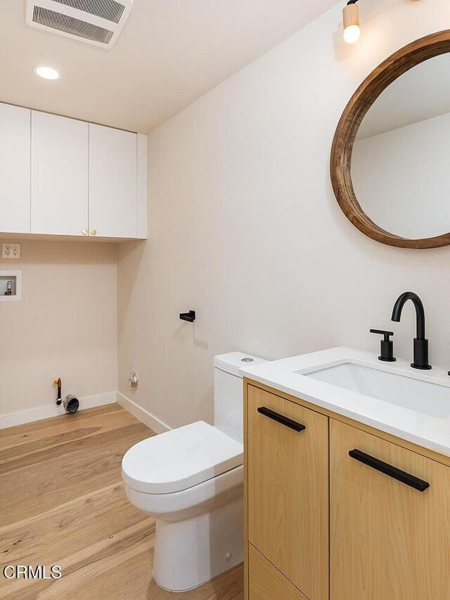 987 Bell St, Pasadena, CA 91104 - half bathroom featuring vanity, wood finished floors, and recessed lighting