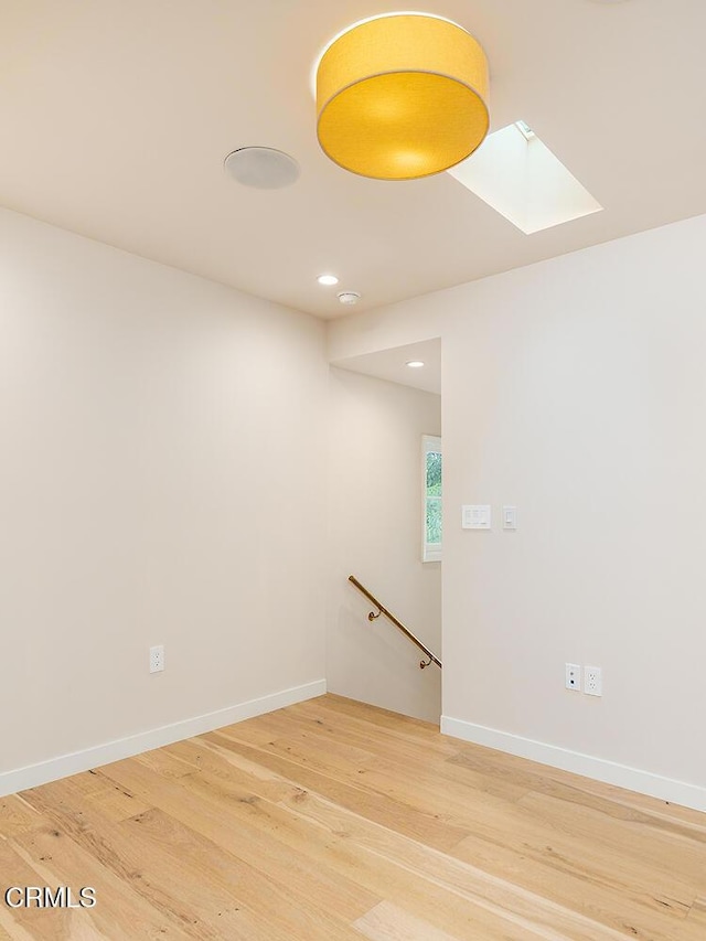 987 Bell St, Pasadena, CA 91104 - spare room featuring light wood-style flooring, a skylight, and recessed lighting
