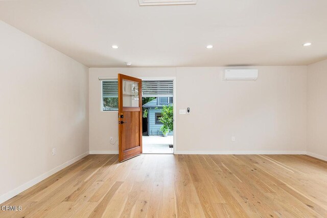 987 Bell St, Pasadena, CA 91104 - unfurnished room with light wood-style flooring, a wall mounted air conditioner, and recessed lighting