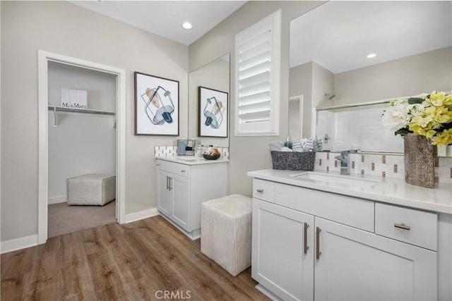13902 Hidden Pines Ct, Victorville, CA 92392 - bathroom featuring an enclosed shower, wood finished floors, two vanities, and recessed lighting