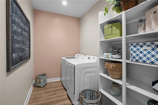 13902 Hidden Pines Ct, Victorville, CA 92392 - laundry area with washing machine and clothes dryer and wood finished floors