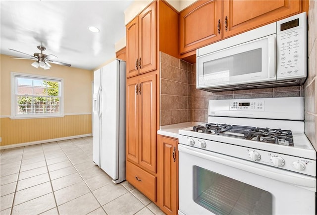 6116 Choctaw Dr, Westminster, CA 92683 - kitchen with white appliances, light tile patterned flooring, light countertops, ceiling fan, and wainscoting