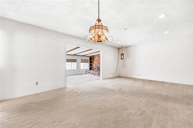 6116 Choctaw Dr, Westminster, CA 92683 - unfurnished room with light carpet, a chandelier, a textured ceiling, recessed lighting, and a fireplace