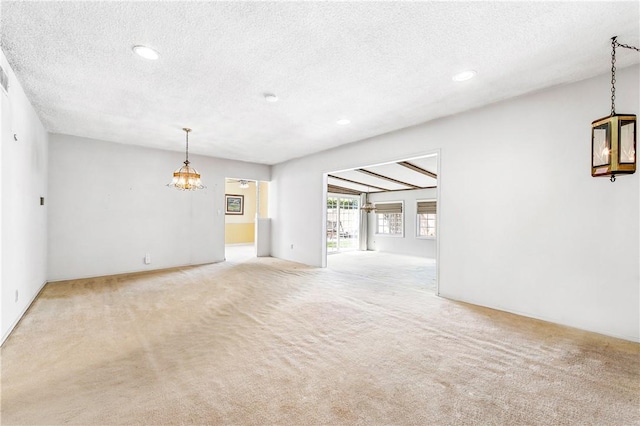 6116 Choctaw Dr, Westminster, CA 92683 - unfurnished living room with a textured ceiling, a chandelier, light carpet, and recessed lighting