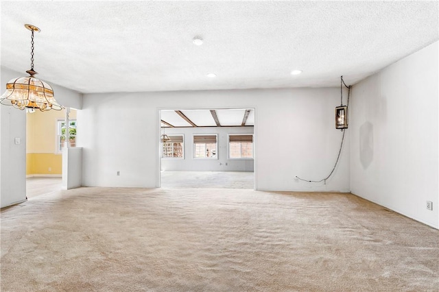 6116 Choctaw Dr, Westminster, CA 92683 - unfurnished living room featuring a chandelier, carpet floors, healthy amount of natural light, a textured ceiling, and recessed lighting