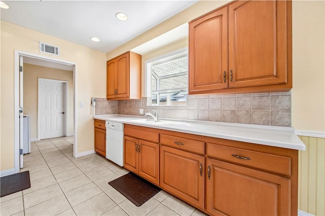 6116 Choctaw Dr, Westminster, CA 92683 - kitchen with dishwasher, light countertops, tasteful backsplash, light tile patterned flooring, and brown cabinetry