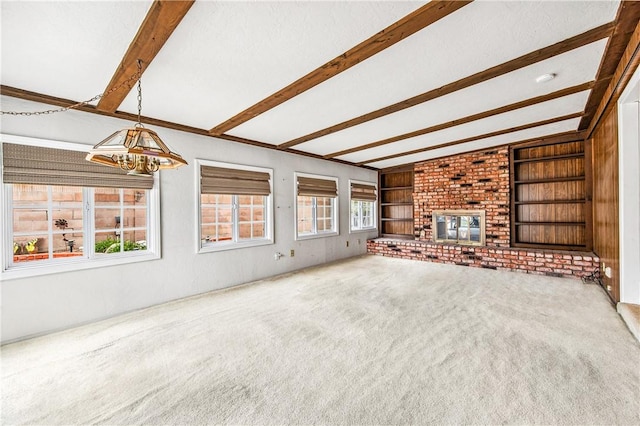 6116 Choctaw Dr, Westminster, CA 92683 - unfurnished living room featuring beam ceiling, carpet, a fireplace, a chandelier, and built in features