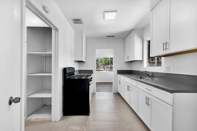 19147 Ingomar St, Reseda, CA 91335 - kitchen featuring gas range oven, dark countertops, and white cabinets