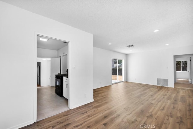 19147 Ingomar St, Reseda, CA 91335 - unfurnished living room featuring plenty of natural light, wood finished floors, recessed lighting, and a textured ceiling
