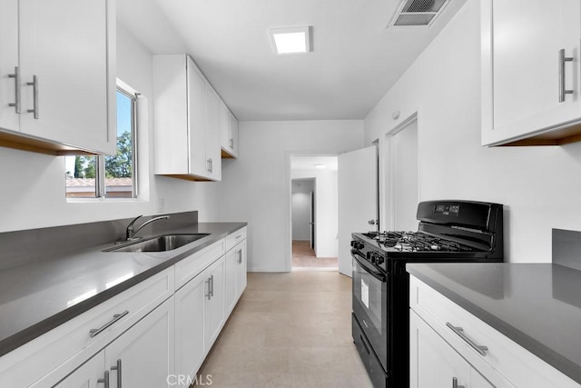 19147 Ingomar St, Reseda, CA 91335 - kitchen with black gas range oven, white cabinetry, dark countertops, and light flooring
