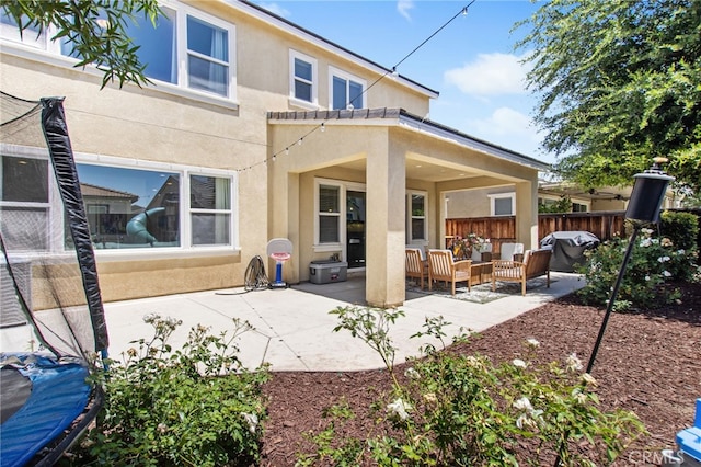 29443 Moorings Ct, Menifee, CA 92585 - rear view of property featuring stucco siding, outdoor lounge area, and a patio