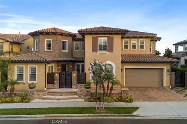 2282 E Rosecrans Ct, Brea, CA 92821 - view of front of house featuring a tile roof, driveway, a gate, and stucco siding