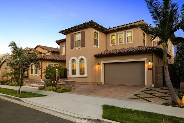 2282 E Rosecrans Ct, Brea, CA 92821 - mediterranean / spanish-style home with a tile roof, decorative driveway, stucco siding, and an attached garage