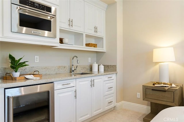 2282 E Rosecrans Ct, Brea, CA 92821 - kitchen featuring wine cooler, white cabinetry, stainless steel oven, open shelves, and light stone counters