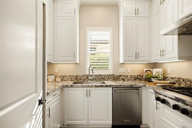 2282 E Rosecrans Ct, Brea, CA 92821 - kitchen with under cabinet range hood, white cabinets, light stone counters, and stainless steel gas cooktop