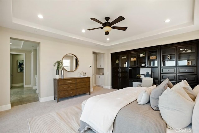 2282 E Rosecrans Ct, Brea, CA 92821 - bedroom with a tray ceiling, light colored carpet, built in study area, recessed lighting, and a ceiling fan