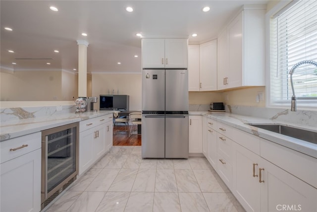 1741 Wabasso Way, Glendale, CA 91208 - kitchen featuring freestanding refrigerator, beverage cooler, crown molding, white cabinets, and light stone counters