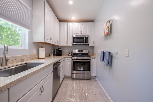1741 Wabasso Way, Glendale, CA 91208 - kitchen featuring appliances with stainless steel finishes, white cabinetry, light stone countertops, and recessed lighting