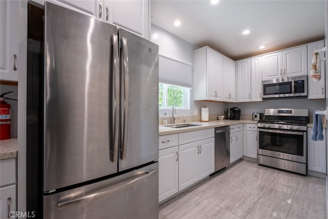 1741 Wabasso Way, Glendale, CA 91208 - kitchen featuring appliances with stainless steel finishes, light countertops, white cabinetry, recessed lighting, and light tile patterned floors