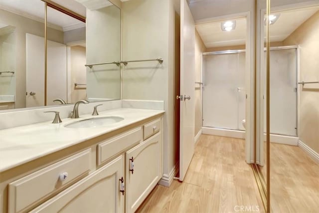 4001 Calle Sonora Unit 3E, Laguna Woods, CA 92637 - bathroom with wood finished floors, vanity, a shower stall, and crown molding
