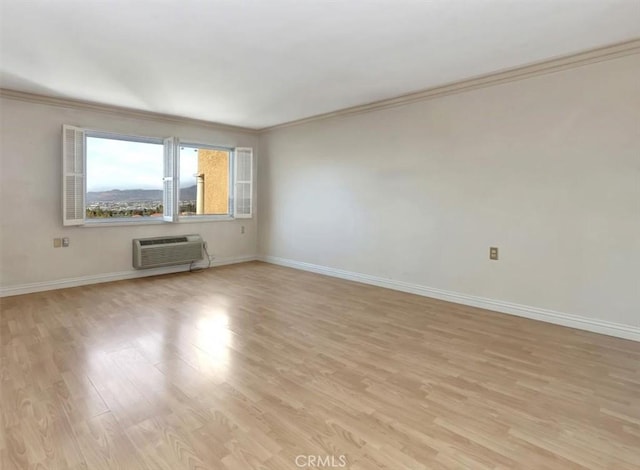 4001 Calle Sonora Unit 3E, Laguna Woods, CA 92637 - unfurnished room featuring crown molding, light wood-style flooring, and a wall mounted AC