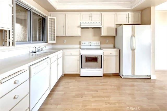 4001 Calle Sonora Unit 3E, Laguna Woods, CA 92637 - kitchen with white appliances, under cabinet range hood, crown molding, a tray ceiling, and light wood finished floors
