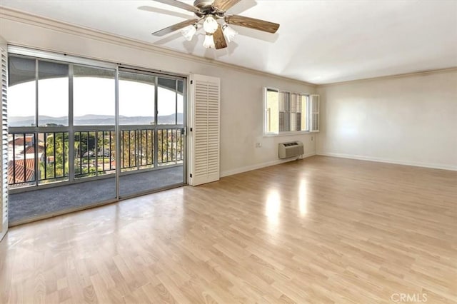 4001 Calle Sonora Unit 3E, Laguna Woods, CA 92637 - empty room with ornamental molding, a wall mounted air conditioner, light wood finished floors, ceiling fan, and healthy amount of natural light