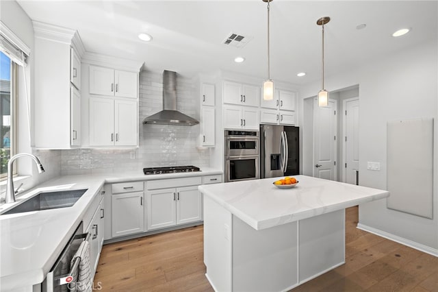 3372 Ivy Way, Rancho Mission Viejo, CA 92694 - kitchen with appliances with stainless steel finishes, wall chimney exhaust hood, light wood finished floors, backsplash, and recessed lighting