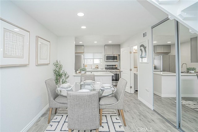 15300 Ocaso Ave Unit E102, La Mirada, CA 90638 - dining area with light wood-style flooring and recessed lighting