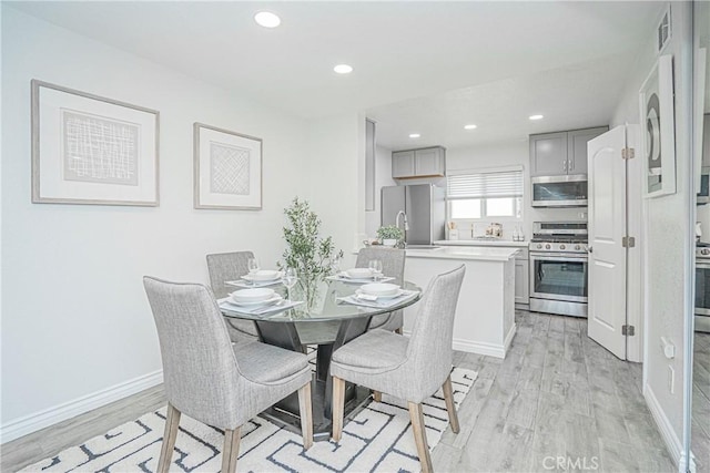 15300 Ocaso Ave Unit E102, La Mirada, CA 90638 - dining space featuring light wood-style floors and recessed lighting