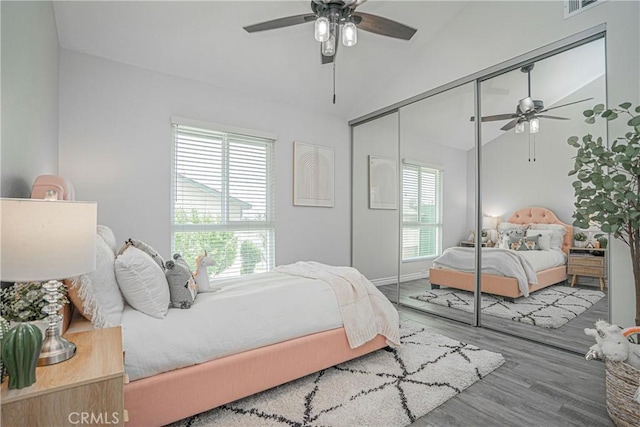 15300 Ocaso Ave Unit E102, La Mirada, CA 90638 - bedroom featuring wood finished floors, a closet, lofted ceiling, and a ceiling fan