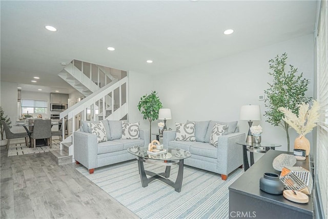 15300 Ocaso Ave Unit E102, La Mirada, CA 90638 - living room with stairs, light wood-style floors, and recessed lighting