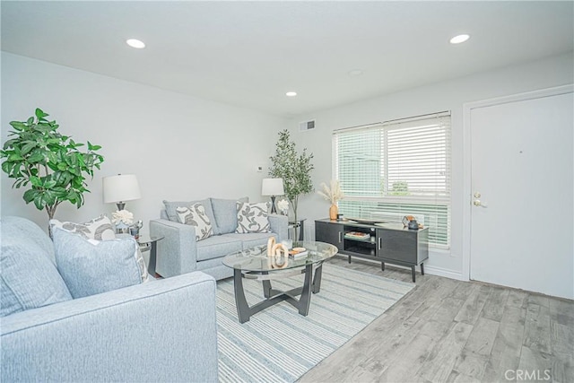 15300 Ocaso Ave Unit E102, La Mirada, CA 90638 - living room featuring light wood finished floors and recessed lighting