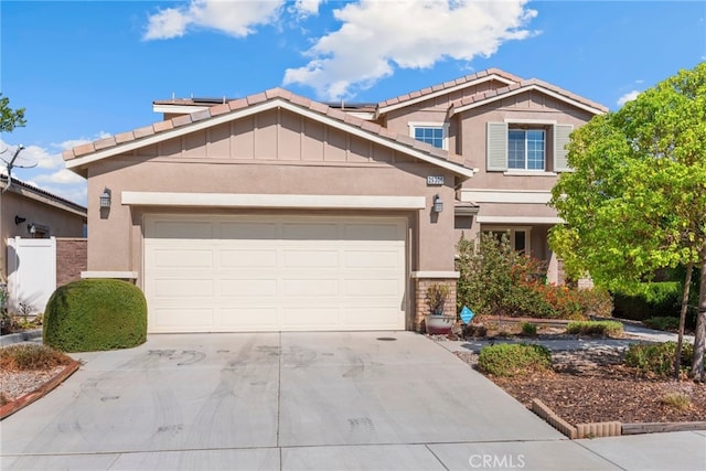 29306 St Andrews, Lake Elsinore, CA 92530 - view of front of home featuring concrete driveway, stucco siding, roof mounted solar panels, and a garage
