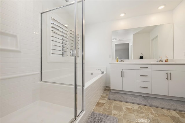 27240 Lost Palm St, Menifee, CA 92585 - bathroom featuring double vanity, a stall shower, a garden tub, stone finish flooring, and recessed lighting