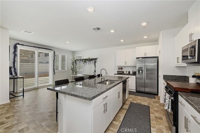 27240 Lost Palm St, Menifee, CA 92585 - kitchen featuring stainless steel appliances, an island with sink, a breakfast bar, recessed lighting, and white cabinetry