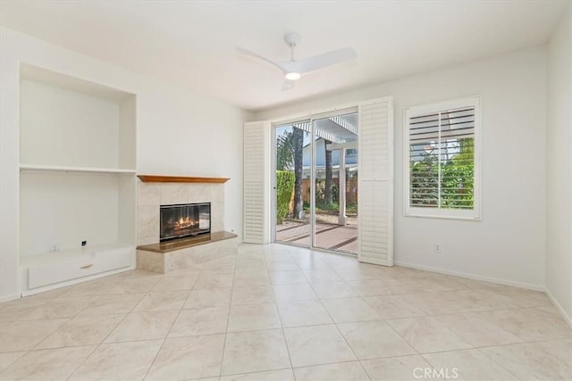 31042 Bunker Dr, Temecula, CA 92591 - unfurnished living room with healthy amount of natural light, a tiled fireplace, tile patterned floors, and a ceiling fan