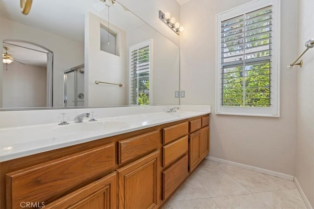 31042 Bunker Dr, Temecula, CA 92591 - full bathroom featuring healthy amount of natural light, double vanity, a shower with door, and a ceiling fan