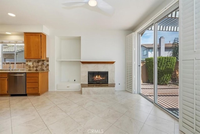 31042 Bunker Dr, Temecula, CA 92591 - unfurnished living room with ceiling fan, a tiled fireplace, light tile patterned floors, and recessed lighting