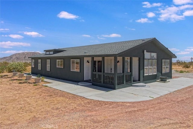 1001 Gibralter Rd, Landers, CA 92285 - rear view of property with a porch, a mountain view, and roof with shingles