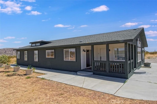 1001 Gibralter Rd, Landers, CA 92285 - view of front of home featuring a shingled roof and a porch