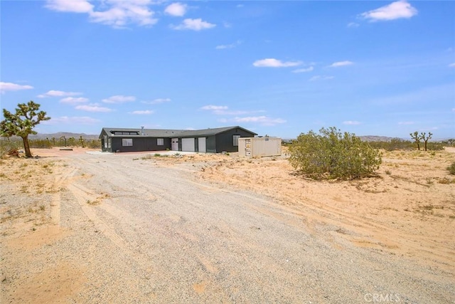 1001 Gibralter Rd, Landers, CA 92285 - view of front of home featuring a garage and dirt driveway