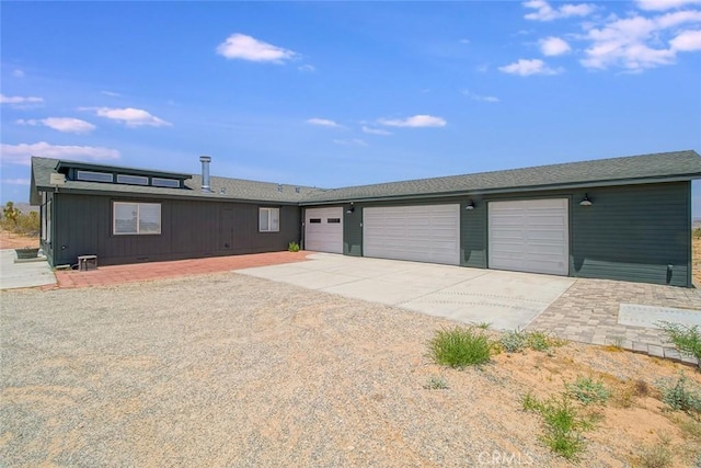 1001 Gibralter Rd, Landers, CA 92285 - view of front facade with concrete driveway and a garage